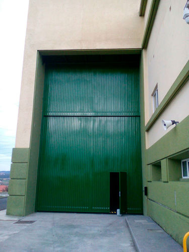 Porta scorrevole verticale - Talleres Alfa Torres - in metallo / industriale / per interno