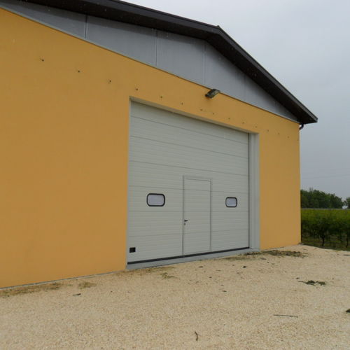 Porta sezionale - Tecnoindustriale s.r.l. - in metallo / da esterno / per hangar