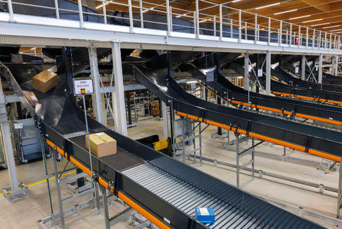 Trasportatore a nastro - .M - VANDERLANDE - a rulli / inclinato / da trasporto