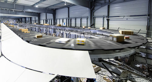 Smistatore a nastro trasversale - GENI-BELT™ - Fives Cinetic SAS - automatizzato / per movimentazione / ad alta velocità